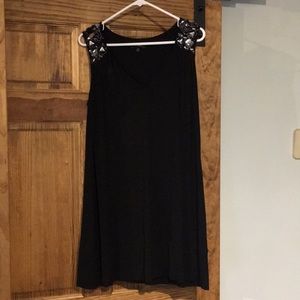Short black sleeveless dress with bejeweled detail